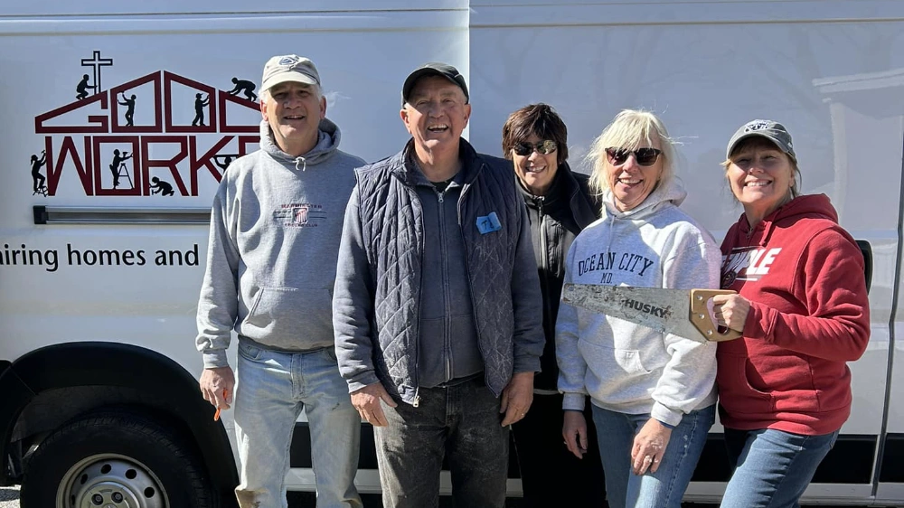 Good Works volunteers in front of a Good Works van