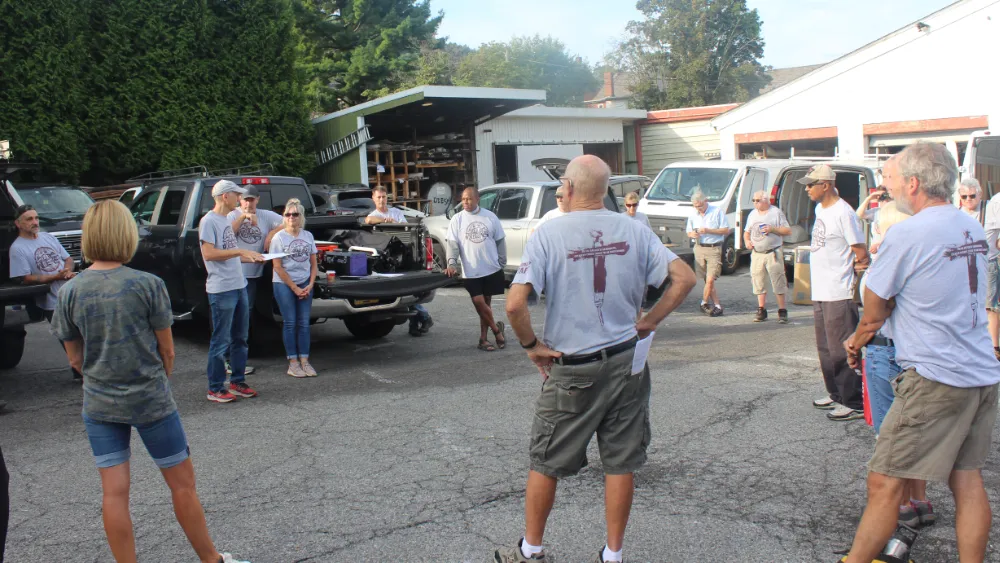 Executive Directory of Good Works, Bob Beggs, leads a meeting of volunteers and staff members.